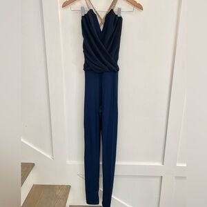 Navy bodysuit dance costume with black blouse overlay and strappy back.